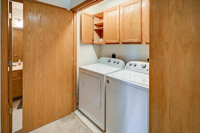 washroom featuring cabinet space and independent washer and dryer