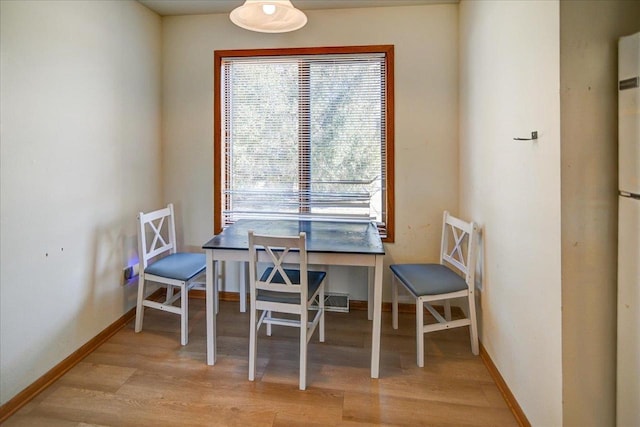 dining room featuring baseboards and wood finished floors