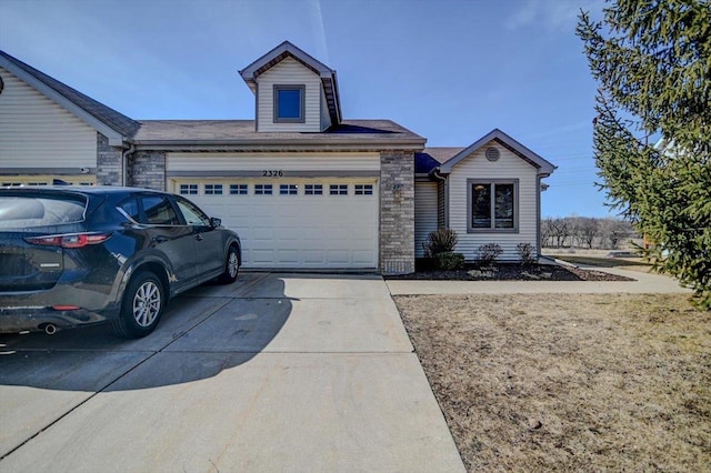 ranch-style home with driveway and an attached garage