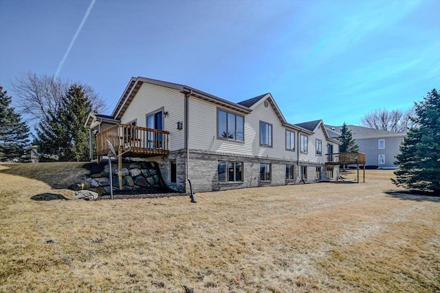 view of side of home with a lawn and a deck