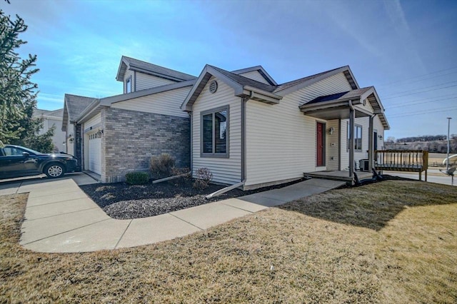 view of property exterior featuring a yard, concrete driveway, and a garage