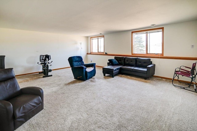 carpeted living area featuring baseboards