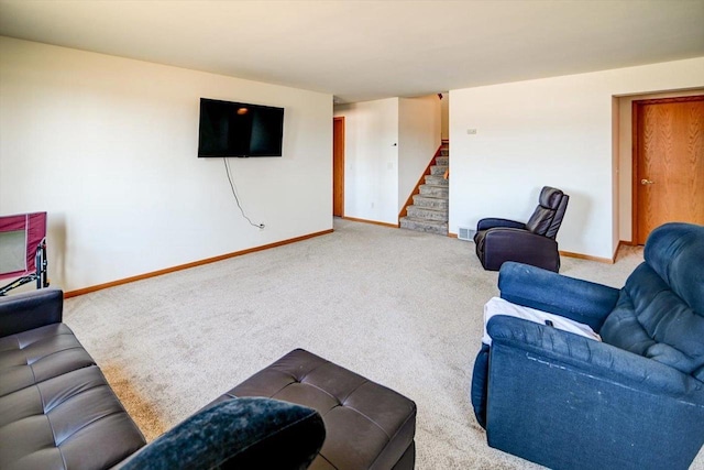 living area with visible vents, stairway, carpet, and baseboards