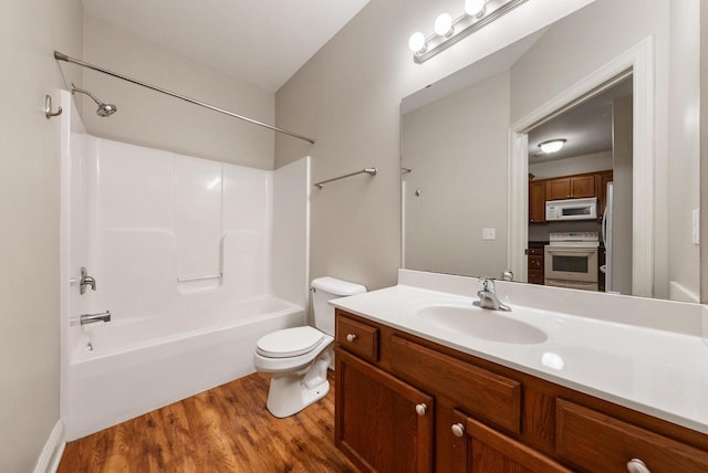 full bathroom with vanity, shower / tub combination, wood finished floors, and toilet