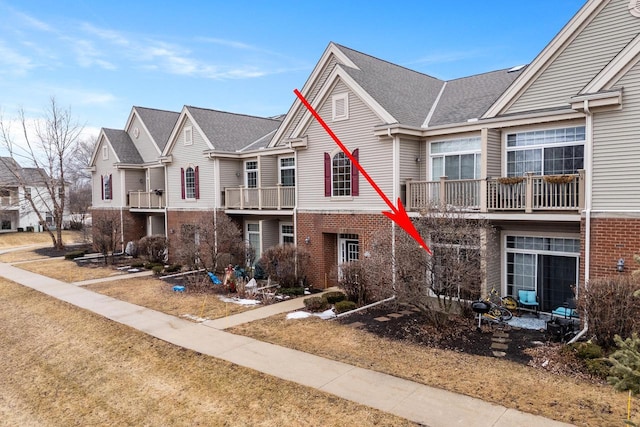 multi unit property featuring a residential view and brick siding