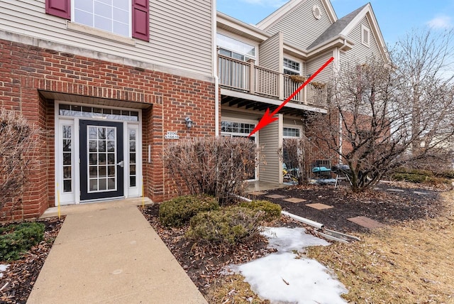 property entrance featuring brick siding