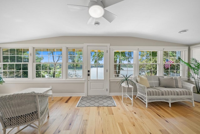 sunroom / solarium featuring a healthy amount of sunlight, vaulted ceiling, and ceiling fan