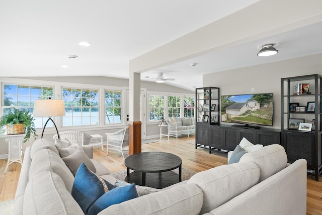 living room with vaulted ceiling, wood finished floors, and baseboards