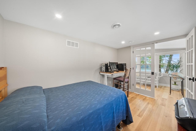 bedroom with light wood finished floors, french doors, visible vents, and recessed lighting