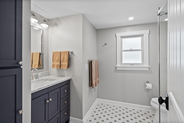 full bathroom featuring toilet, baseboards, and vanity