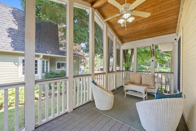 sunroom with lofted ceiling, wooden ceiling, and ceiling fan