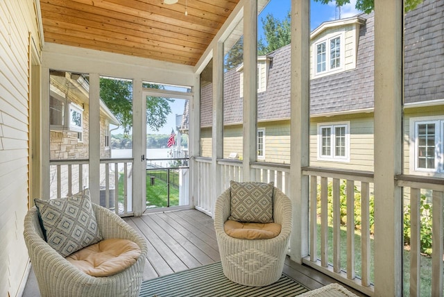 sunroom / solarium featuring a wealth of natural light, wood ceiling, and vaulted ceiling