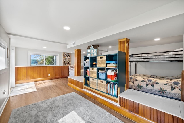 bedroom featuring decorative columns, recessed lighting, visible vents, wainscoting, and wood finished floors