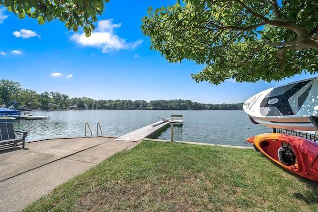 view of dock featuring a lawn and a water view