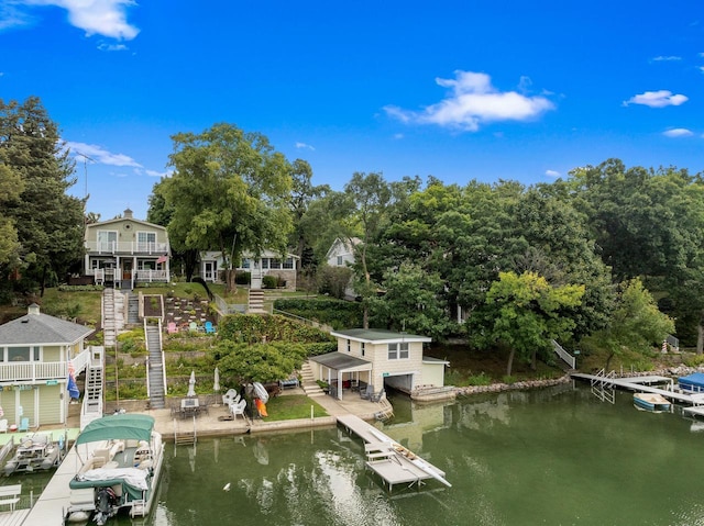 view of dock with stairs, a water view, and boat lift