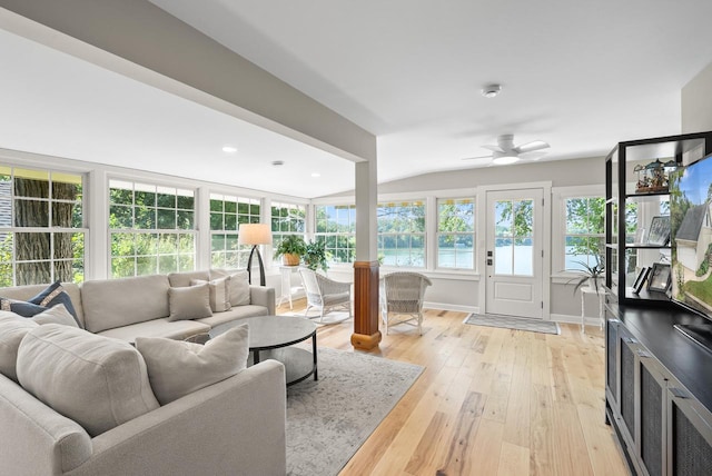 sunroom / solarium with lofted ceiling and ceiling fan