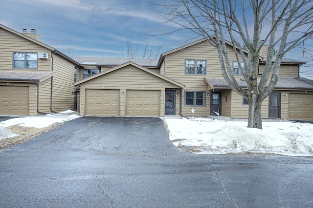 view of front facade featuring aphalt driveway and an attached garage