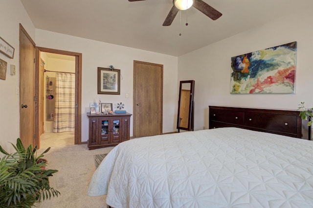 bedroom featuring ensuite bathroom, carpet, and a ceiling fan