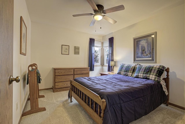 bedroom featuring light carpet, ceiling fan, and baseboards