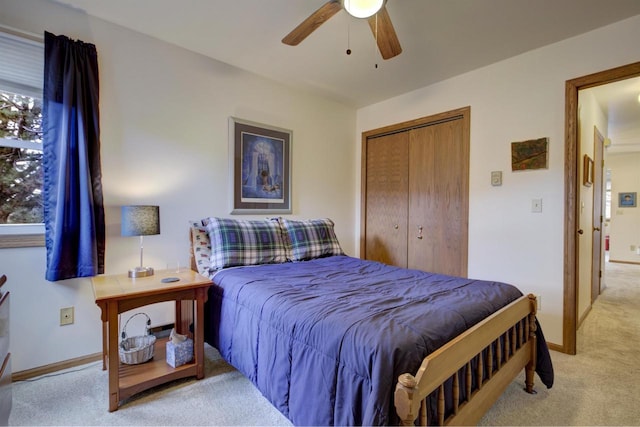 bedroom with a closet, carpet flooring, a ceiling fan, and baseboards