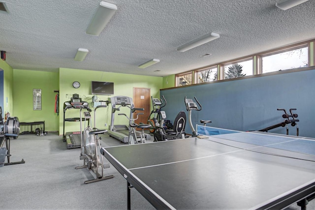 recreation room featuring visible vents and a textured ceiling