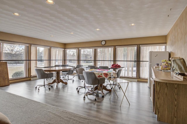 dining space with recessed lighting and wood finished floors