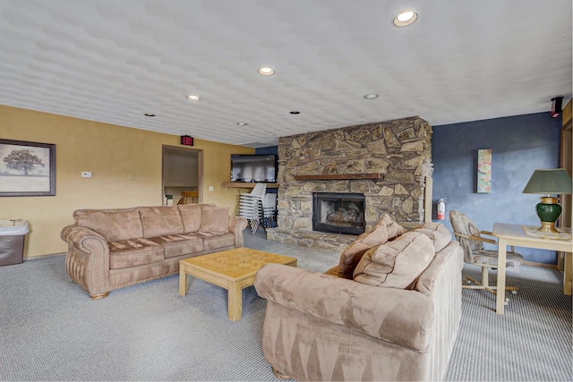 carpeted living area with a fireplace and recessed lighting