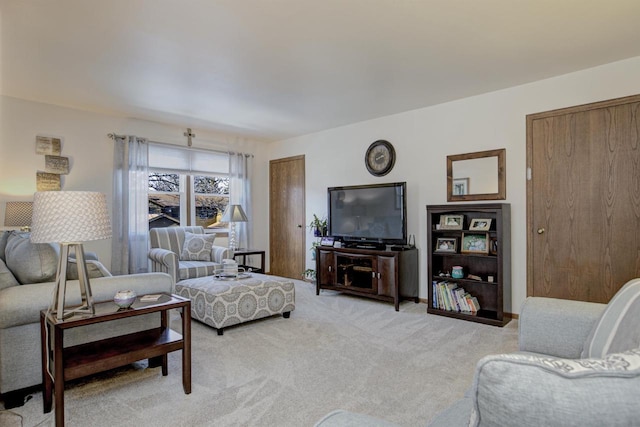 living area featuring light colored carpet and baseboards