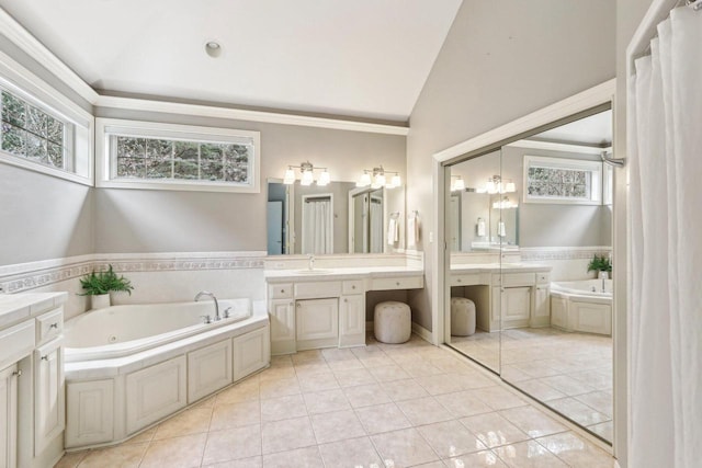 bathroom with a sink, a garden tub, tile patterned flooring, vaulted ceiling, and two vanities