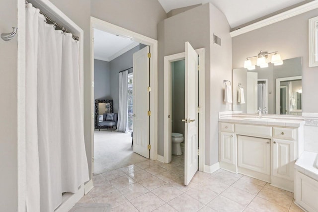 full bath with toilet, vanity, baseboards, tile patterned floors, and crown molding