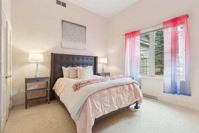 carpeted bedroom with ornamental molding, visible vents, and baseboards