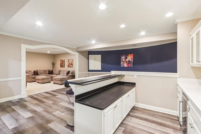 kitchen with ornamental molding, recessed lighting, light wood-style flooring, and white cabinets