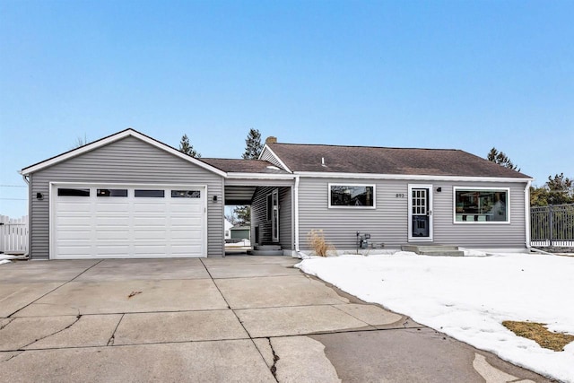 ranch-style home with a garage, concrete driveway, fence, and a shingled roof