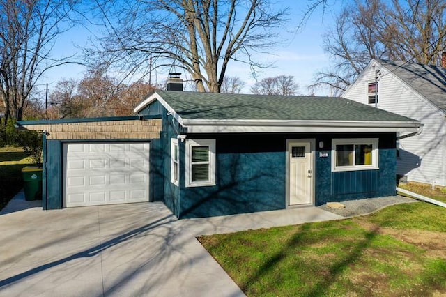 exterior space with concrete driveway, roof with shingles, and an attached garage