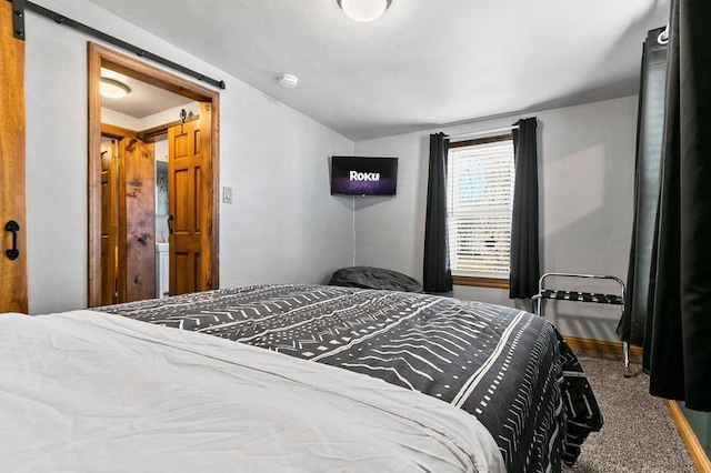 carpeted bedroom with lofted ceiling and a barn door