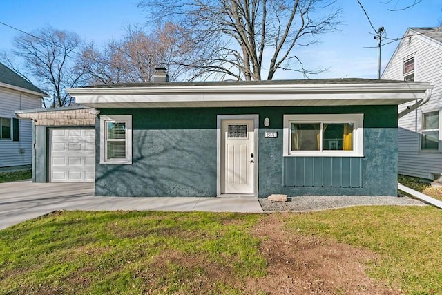 view of front facade featuring board and batten siding, concrete driveway, and an attached garage