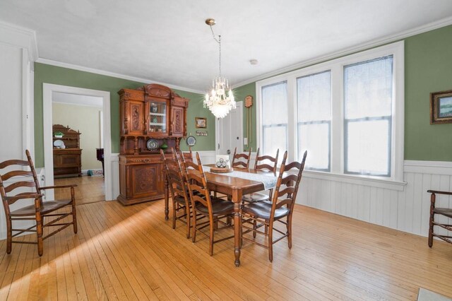 205 State St, Ripon, WI 54971 - dining area with a chandelier, wainscoting, crown molding, and light wood finished floors