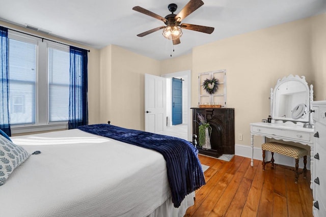 205 State St, Ripon, WI 54971 - bedroom with light wood finished floors, ceiling fan, and baseboards