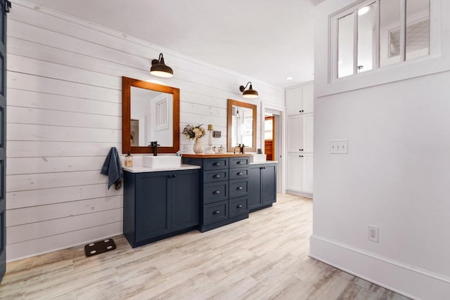 205 State St, Ripon, WI 54971 - full bath with double vanity, a wealth of natural light, a sink, wood finished floors, and baseboards