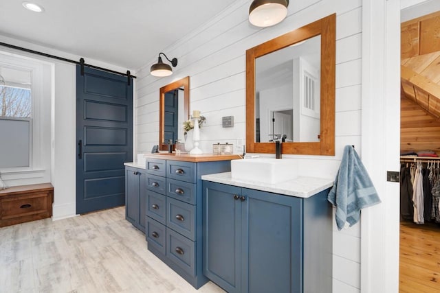 205 State St, Ripon, WI 54971 - bathroom with recessed lighting, two vanities, a sink, and wood finished floors