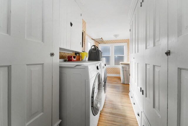 205 State St, Ripon, WI 54971 - laundry room featuring light wood-type flooring, washing machine and dryer, and cabinet space