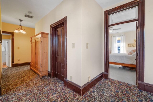 205 State St, Ripon, WI 54971 - hallway featuring a chandelier, carpet, visible vents, and baseboards