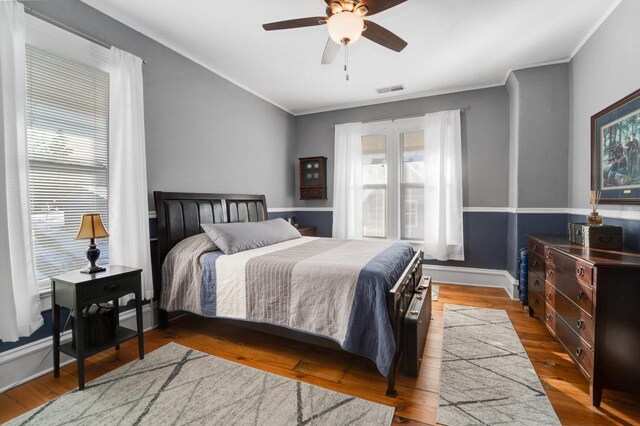 205 State St, Ripon, WI 54971 - bedroom featuring baseboards, visible vents, ceiling fan, wood finished floors, and crown molding