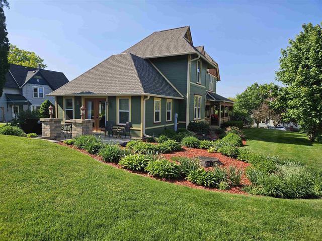 205 State St, Ripon, WI 54971 - back of property with roof with shingles, a lawn, and a patio area
