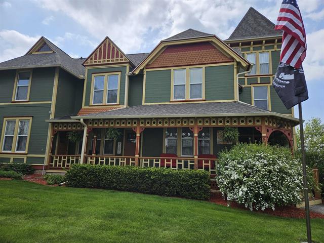 205 State St, Ripon, WI 54971 - view of front of home with covered porch and a front lawn
