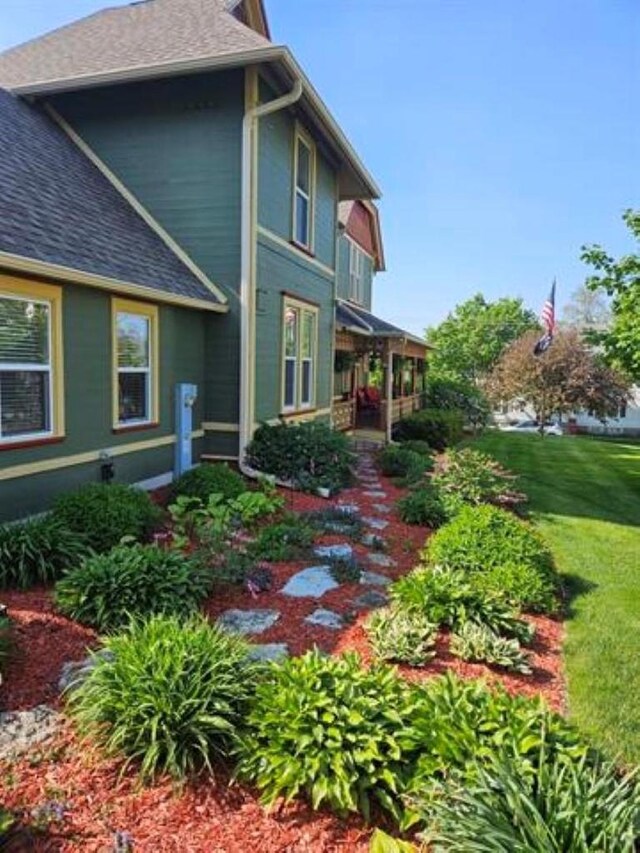 205 State St, Ripon, WI 54971 - rear view of property featuring a lawn and roof with shingles