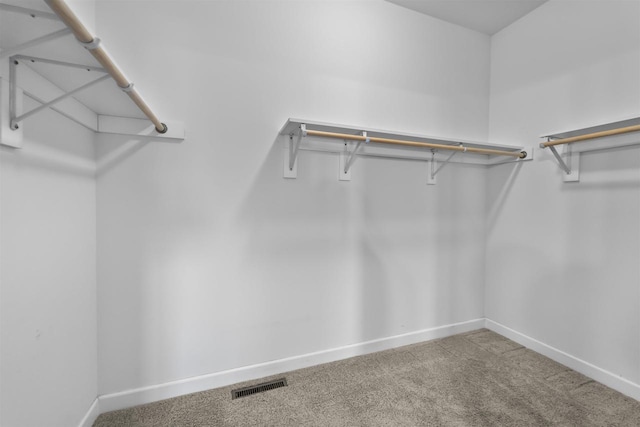 walk in closet featuring carpet floors and visible vents