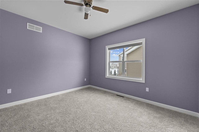 unfurnished room featuring carpet floors, visible vents, ceiling fan, and baseboards