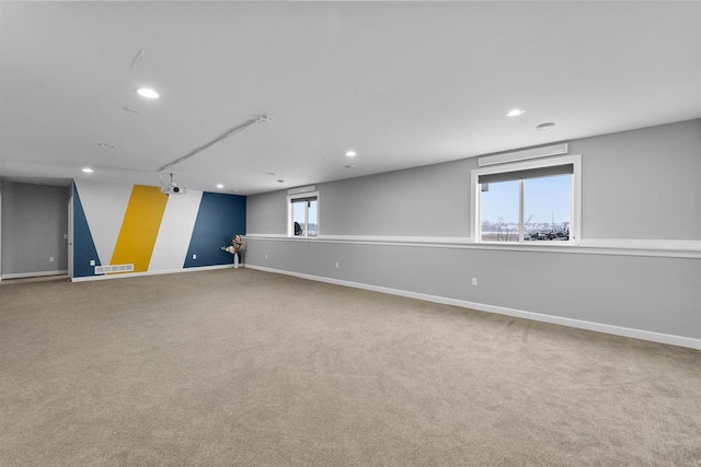 below grade area featuring carpet, baseboards, visible vents, and recessed lighting