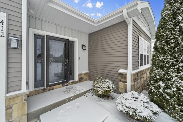 view of snow covered property entrance